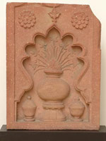 Unknown (India, Mughal) / 
      Stone Panel with Recessed Niche Containing Two Covered Bowls and a
      Larger Vase with Flowers, early 17th century / 
      red sandstone / 
      25 x 18 3/8 x 3 1/2 in. (63.5 x 46.7 x 8.9 cm)  / 
      Private collection / 
        / 
      These types of stone panels are called <em>chini
        khanas</em>, or China Rooms. This, together with the other stone
      panel in the show with a similar design, form a pair of wall niches
      from the same building. They are close in design to architectural
      elements still in situ on the Kanch Mahal (a palace of the Emperor
      Jahangir) dating from ca. 1605-1612, near Agra.