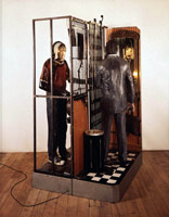 Claude Nigger Claude, 1988 / 
plaster casts, steel elevator door, mirror, sheet metal, wood, clothing, leather, floor tiles, electrical wiring, and lights / 
95 x 55 x 53 in (241.3 x 139.7 x 134.6 cm) / 
Private collection