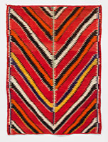 Unknown (Navajo) / 
Navajo Eye-dazzler, circa 1875-1885 / 
Native handspun wool: red, orange,
synthetic dyed / 
86 1/4 x 62 1/2 in. (219.1 x 158.8 cm)
