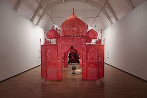 Rina Banerjee / 
Take me, take me, take me…to the Palace of love, 2003 / 
plastic, wood chair, steel and copper framework, floral picks, foam balls, cowrie shells, quilting pins, moss, stone globe, glass, synthetic fabric, fake birds / 
161.4 x 161.4 x 226.4 in. (410 x 410 x 575.1 cm)