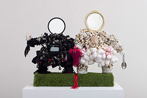 Vanessa German / 
This Togetherness, (Couples Therapy), 2021 / 
love, wood, astroturf, 1 vintage mirror, 1 new mirror, bone beads, sorrow, keys, forgiveness, vision, terror, loneliness, selfishness, blood, hate, shame, rage, cannabis, saltwater, tears, salt, horror, beaded trim, locks and keys, prayer beads: yarn, cotton, textile, desperation, hiding, magic, medicine, healing, measuring spoons, clear quartz, black tourmaline, good sex, bad sex, masturbation, amethyst, brass mask beads, lies, vulnerability, binge eating, cowrie shells, self-loathing, buttons, compromise, eye- contact, slowness, softness, wire, glass beads, tears, agate, grace, mercy / 
25 x 33 x 12 in. (63.5 x 83.8 x 30.5 cm)