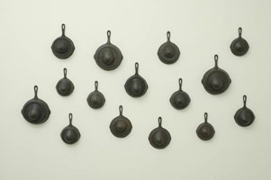 Suckle, 2006 / 
      15 cast bronze elements / 
      Installed dimensions: 44 x 82 x 5 in. (111.8 x 208.3 x 12.7 cm) / 
      Private collection 