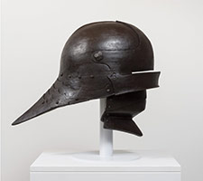 Ben Jackel / 
Sallet with Bevor, 2016 / 
stoneware and beeswax / 
Helmet: 21 1/2 x 30 1/4 x 18 1/2 in. (54.6 x 76.8 x 47 cm) / 
Helmet on Stand: 26 1/2 x 30 1/4 x 18 1/2 in. (67.3 x 76.8 x 47 cm)